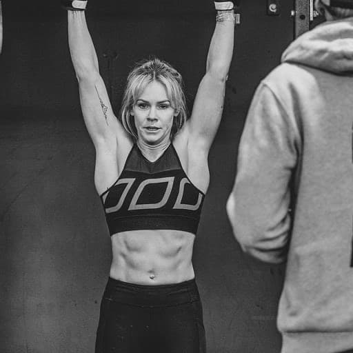 CrossFit Hibiscus Coast member hanging from a bar during a workout