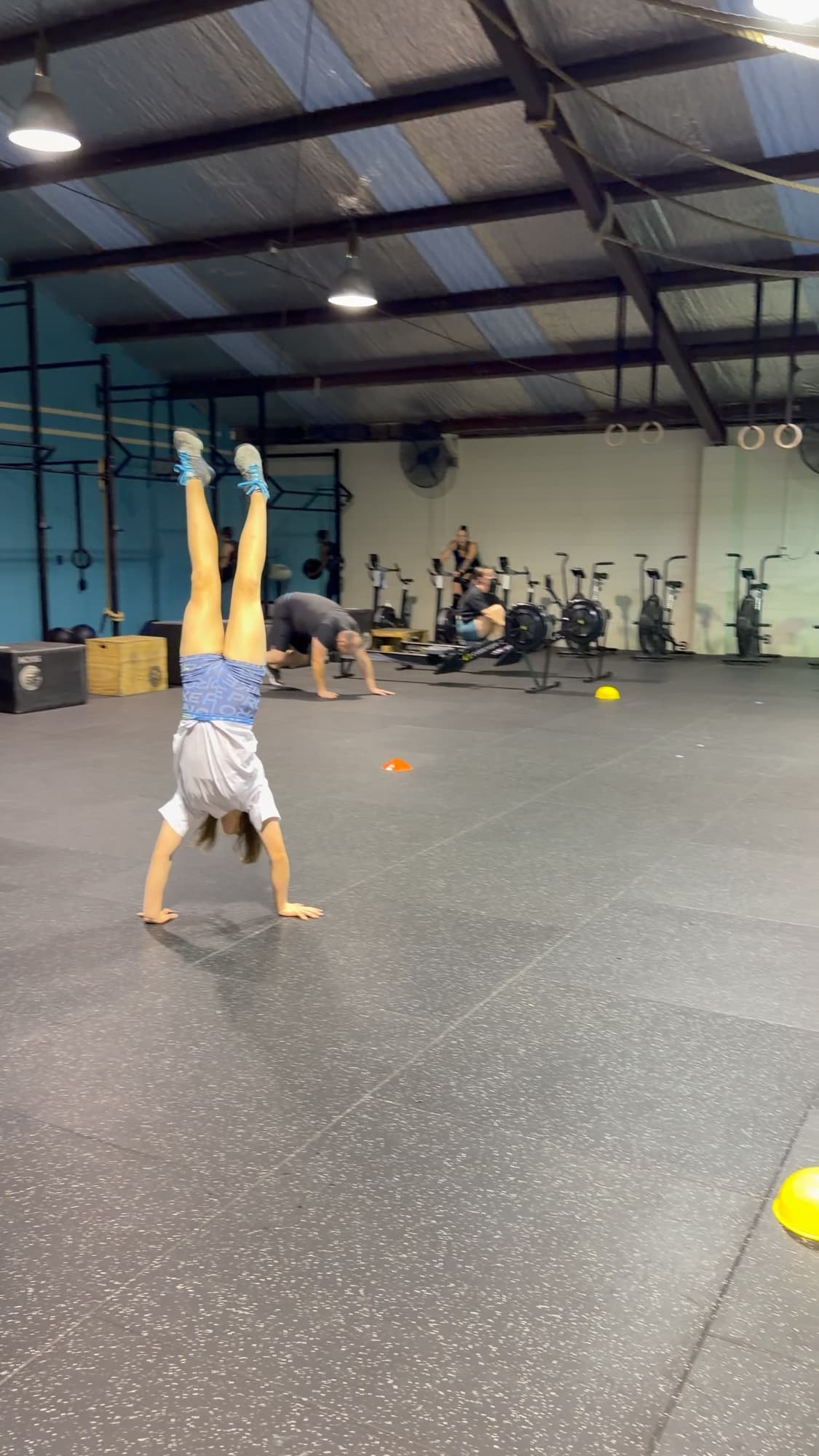 A young athlete practising a handstand during a Kids and Teens session at CrossFit Hibiscus Coast